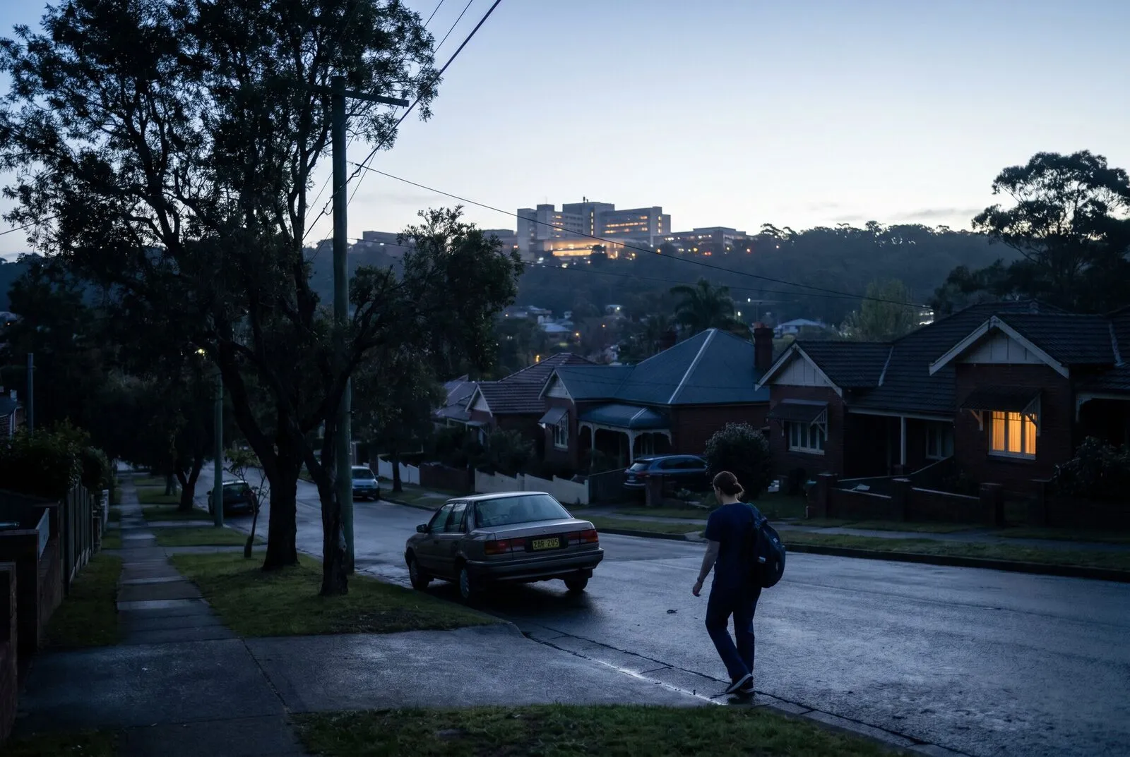 A dawn street on the New Lambton Heights ridge with hospital buildings faint in the background
